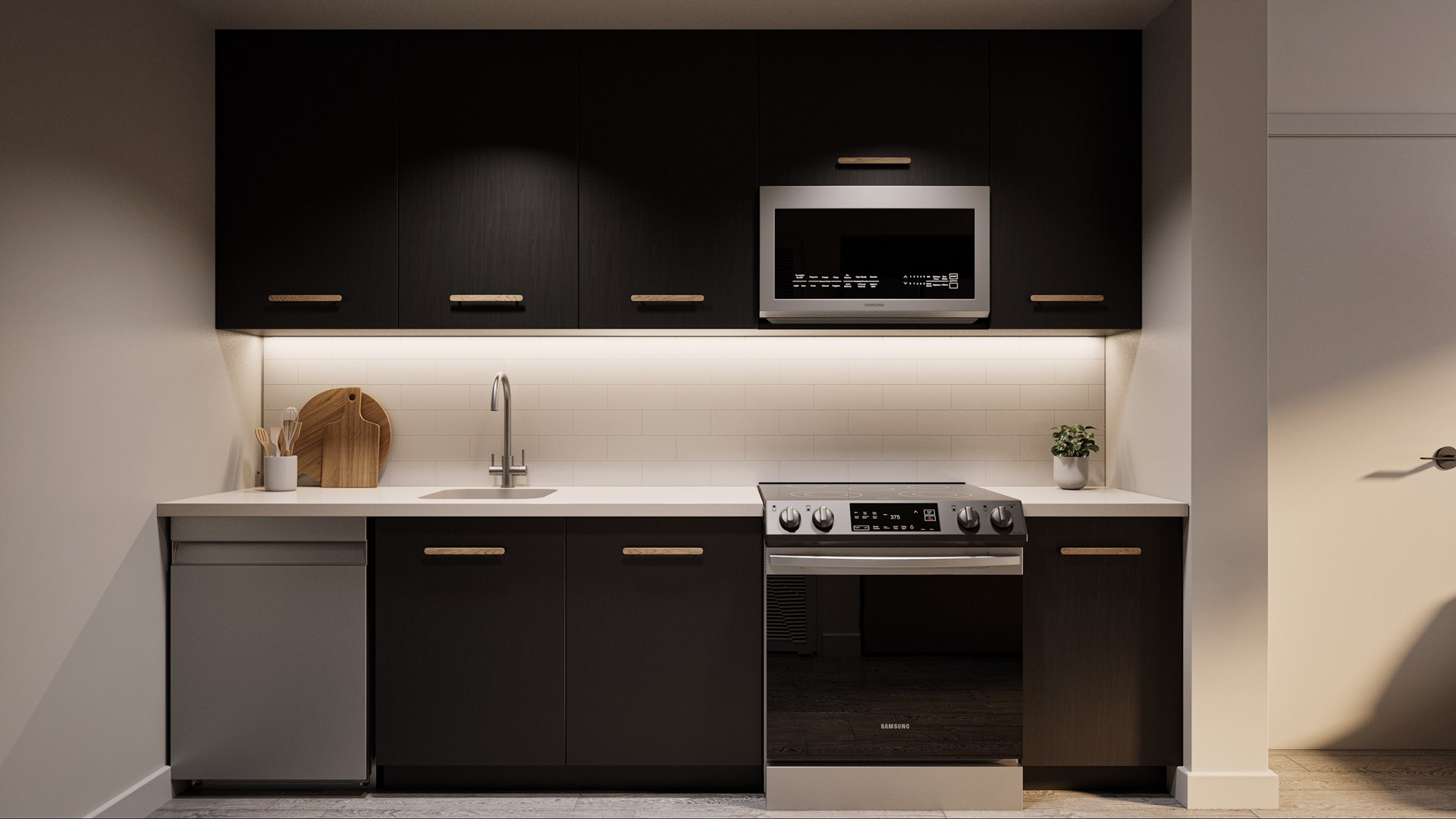 a kitchen with black cabinets and a sink and a microwave